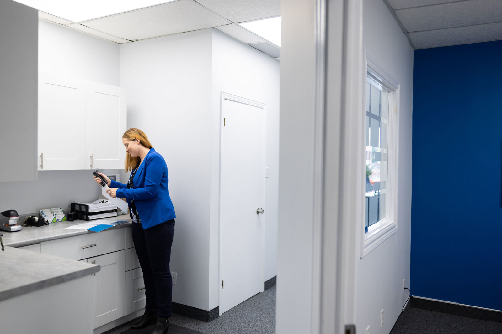 Someone stapling papers together